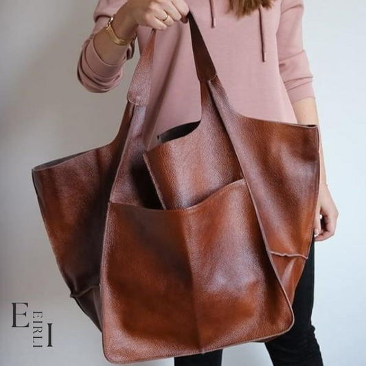 <img src="brown-handbag.jpg" alt=" A beautiful brown handbag carried by a woman official website www.eirlistore.com">