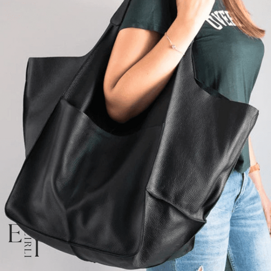 <img src="black-handbag.jpg" alt=" A beautiful black handbag carried by a woman official website www.eirlistore.com">